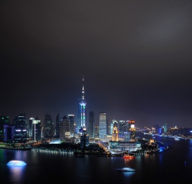 Shanghai Skyline of Pudong by night with boats on Huangpu river, 2011