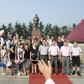 Visitor’s group at village plaza with Mao statue at Maos birthplace village Shaoshan in Hunan province- brandeins