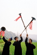 Miao village men greeting guest with trumpets, close to Duyun