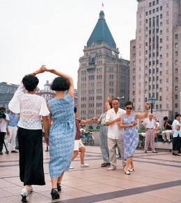 Shanghai, People dance on the  Bund in front of the Peace Hotel