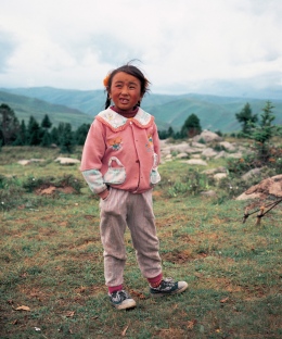 little girl, helping taking care of her family’s Yaks, mountain side, Tagong Sichuan